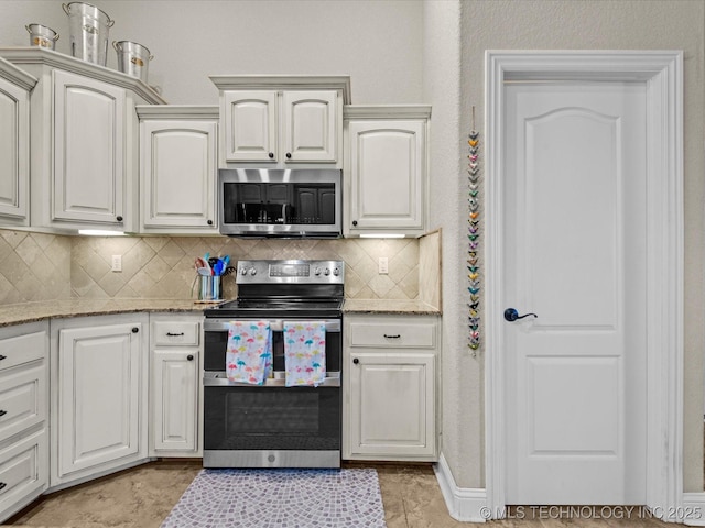 5719 Nottingham Pl, Bartlesville, OK 74006 - kitchen featuring appliances with stainless steel finishes, tasteful backsplash, and light stone counters