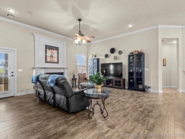 5719 Nottingham Pl, Bartlesville, OK 74006 - living area featuring wood finished floors, a fireplace, ceiling fan, ornamental molding, and recessed lighting