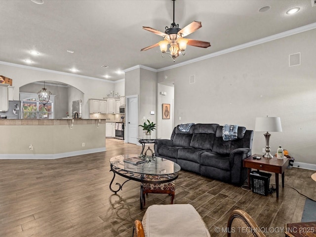 5719 Nottingham Pl, Bartlesville, OK 74006 - living room with wood finished floors, arched walkways, a ceiling fan, ornamental molding, and recessed lighting