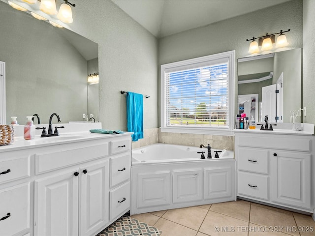 5719 Nottingham Pl, Bartlesville, OK 74006 - bathroom with two vanities, tile patterned flooring, a bath, and a textured wall