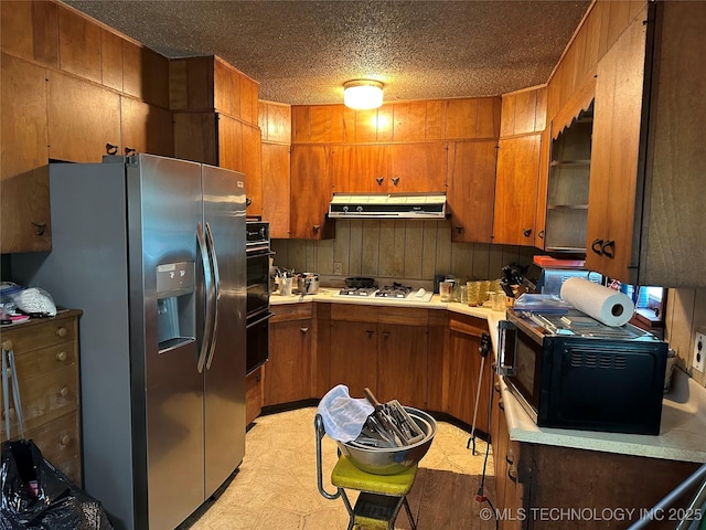 4950 E 41st St N, Tulsa, OK 74115 - kitchen featuring stainless steel fridge with ice dispenser, range hood, black microwave, brown cabinets, and a textured ceiling