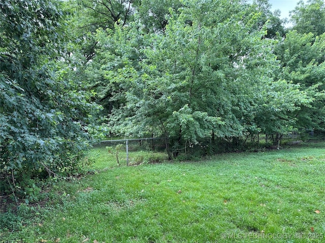 4950 E 41st St N, Tulsa, OK 74115 - view of yard with a wooded view