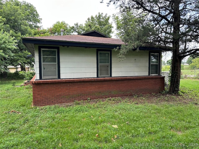 4950 E 41st St N, Tulsa, OK 74115 - view of side of property featuring brick siding and a lawn