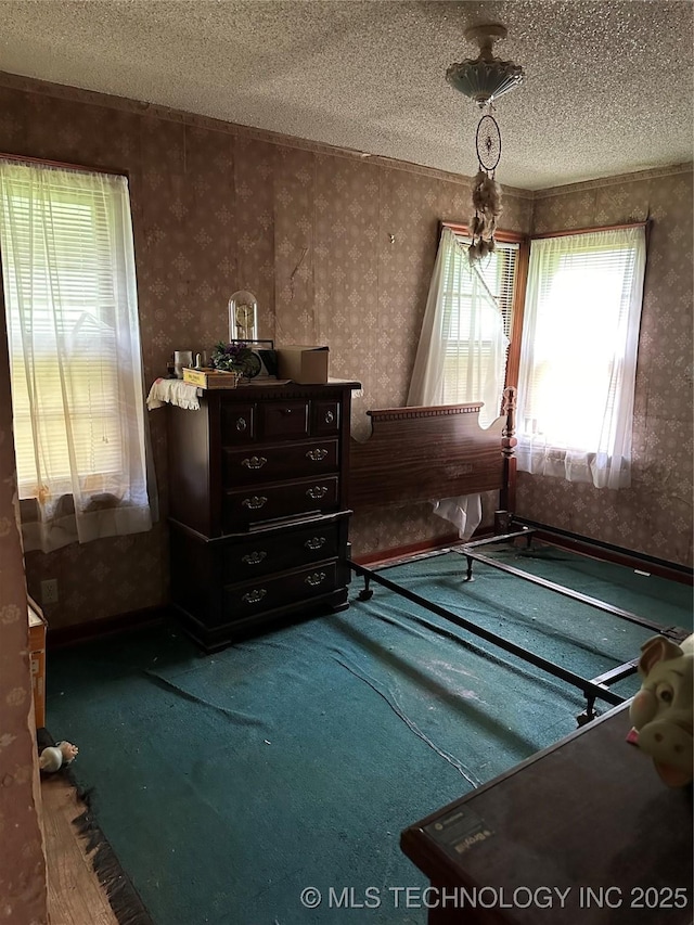 4950 E 41st St N, Tulsa, OK 74115 - bedroom featuring wallpapered walls, a textured ceiling, and carpet floors