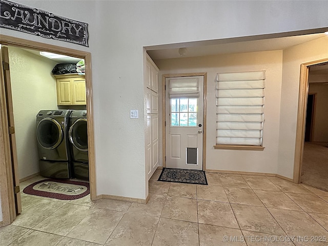 1530 Persimmon, Ardmore, OK 73401 - laundry room featuring washing machine and clothes dryer, cabinet space, and light tile patterned floors