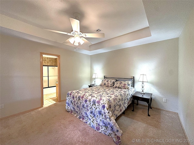 1530 Persimmon, Ardmore, OK 73401 - bedroom featuring carpet, a tray ceiling, a ceiling fan, and a textured wall