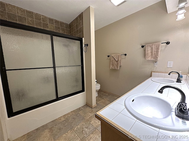 1530 Persimmon, Ardmore, OK 73401 - bathroom with shower / bath combination with glass door, stone finish floors, and double vanity