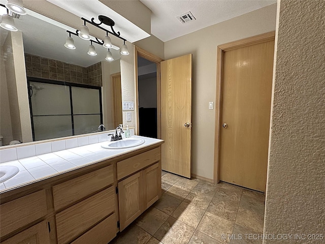 1530 Persimmon, Ardmore, OK 73401 - full bathroom with double vanity and an enclosed shower