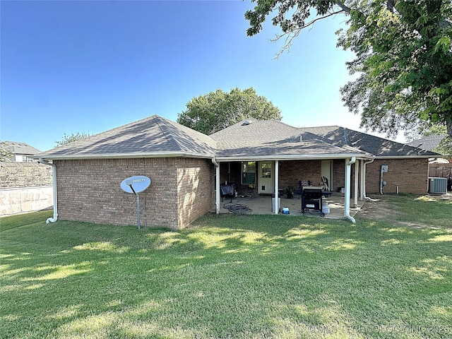 1530 Persimmon, Ardmore, OK 73401 - back of house with a patio area, brick siding, a yard, and roof with shingles