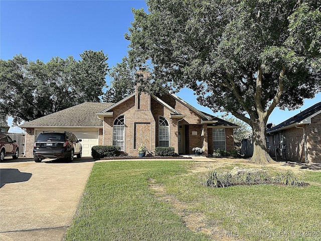 1530 Persimmon, Ardmore, OK 73401 - view of front of property with brick siding, an attached garage, concrete driveway, a front yard, and a chimney