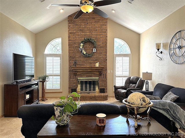 1530 Persimmon, Ardmore, OK 73401 - living area with ceiling fan, lofted ceiling, a fireplace, a textured wall, and a textured ceiling