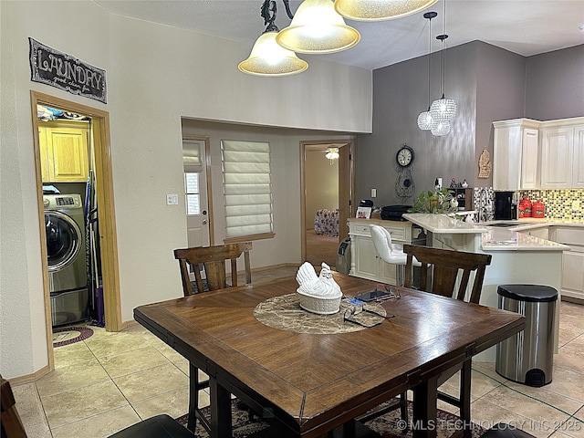 1530 Persimmon, Ardmore, OK 73401 - dining room featuring washer / dryer, light tile patterned floors, and a chandelier