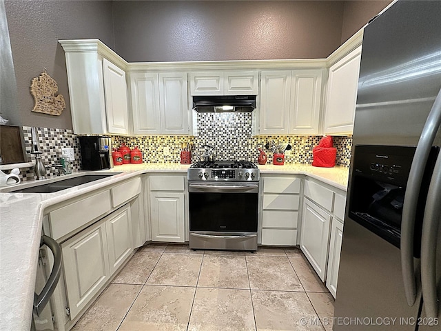 1530 Persimmon, Ardmore, OK 73401 - kitchen with appliances with stainless steel finishes, range hood, tasteful backsplash, light countertops, and a textured wall