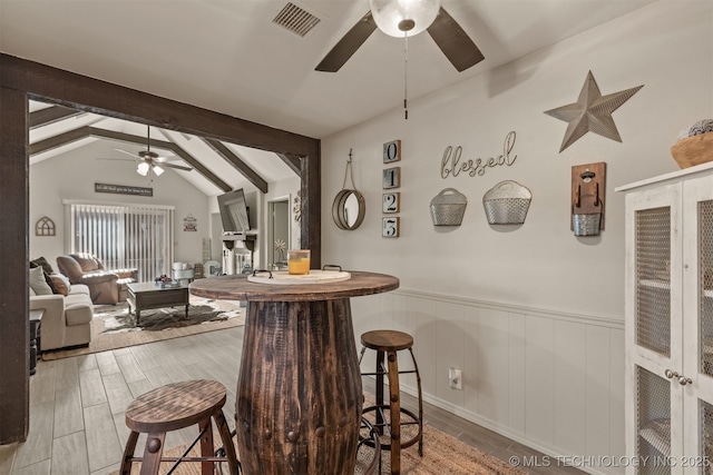 15917 E 131st St Unit 93, Broken Arrow, OK 74011 - bar area featuring a ceiling fan, wainscoting, and wood finished floors