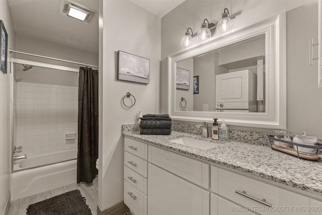 15917 E 131st St Unit 93, Broken Arrow, OK 74011 - bathroom with estacked washer and dryer, vanity, shower / tub combo, and wood finished floors