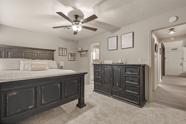 15917 E 131st St Unit 93, Broken Arrow, OK 74011 - bedroom with light colored carpet, connected bathroom, and a ceiling fan