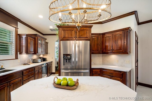 6797 Hummingbird Ct, Owasso, OK 74055 - kitchen with stainless steel fridge, backsplash, crown molding, glass insert cabinets, and beverage cooler