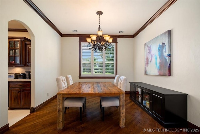 6797 Hummingbird Ct, Owasso, OK 74055 - dining area featuring a chandelier, ornamental molding, wood finished floors, and arched walkways