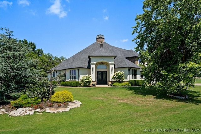 6797 Hummingbird Ct, Owasso, OK 74055 - french country inspired facade featuring french doors, a front yard, stucco siding, and roof with shingles