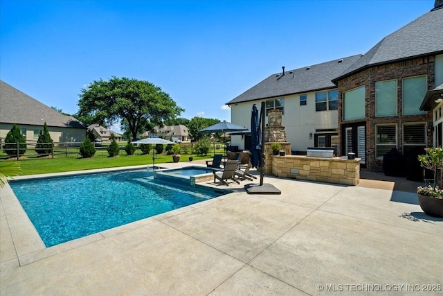 6797 Hummingbird Ct, Owasso, OK 74055 - view of pool with an outdoor kitchen, a patio, and a pool with connected hot tub
