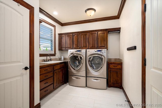 6797 Hummingbird Ct, Owasso, OK 74055 - laundry area featuring cabinet space, ornamental molding, independent washer and dryer, and light tile patterned flooring