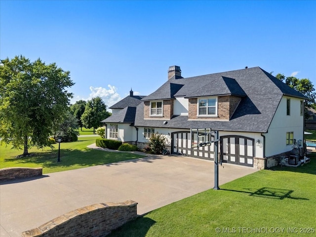 6797 Hummingbird Ct, Owasso, OK 74055 - view of front of property featuring a chimney, driveway, a garage, a front yard, and a shingled roof