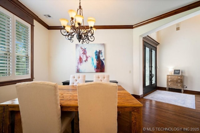 6797 Hummingbird Ct, Owasso, OK 74055 - dining area with a chandelier, crown molding, dark wood-style floors, and french doors