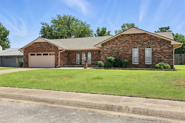 6627 Castle Ct, Bartlesville, OK 74006 - ranch-style home with brick siding, a garage, a front yard, and concrete driveway