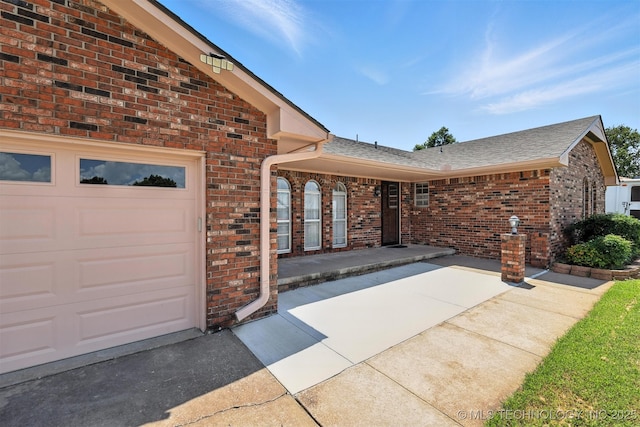 6627 Castle Ct, Bartlesville, OK 74006 - view of front of house with brick siding, roof with shingles, and an attached garage