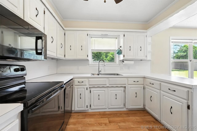 6627 Castle Ct, Bartlesville, OK 74006 - kitchen featuring black appliances, plenty of natural light, light countertops, and crown molding