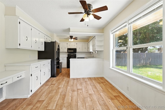 6627 Castle Ct, Bartlesville, OK 74006 - kitchen with black appliances, a ceiling fan, light wood-style flooring, white cabinetry, and light countertops