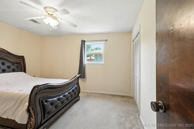 6627 Castle Ct, Bartlesville, OK 74006 - carpeted bedroom with a textured ceiling, a closet, and ceiling fan