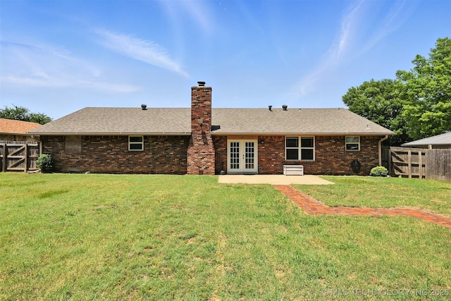 6627 Castle Ct, Bartlesville, OK 74006 - rear view of house featuring french doors, a chimney, a fenced backyard, and a patio