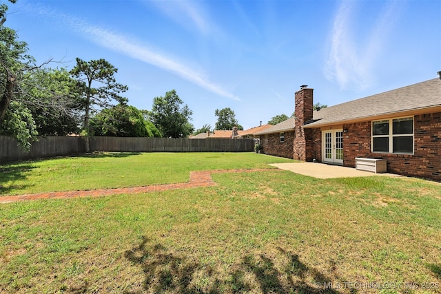 6627 Castle Ct, Bartlesville, OK 74006 - fenced backyard featuring french doors and a patio