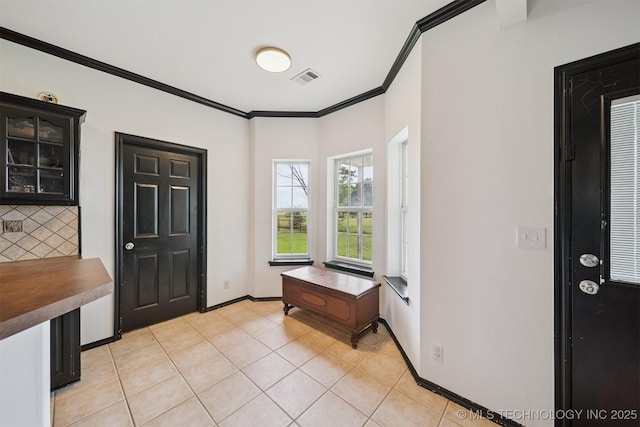 1018 W Evergreen St, Skiatook, OK 74070 - entrance foyer featuring ornamental molding and light tile patterned floors