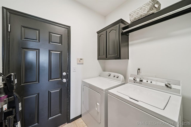 1018 W Evergreen St, Skiatook, OK 74070 - laundry area with cabinet space, washer and clothes dryer, and light tile patterned floors