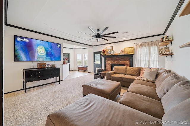 1018 W Evergreen St, Skiatook, OK 74070 - carpeted living area featuring a raised ceiling, ceiling fan, ornamental molding, a fireplace, and recessed lighting