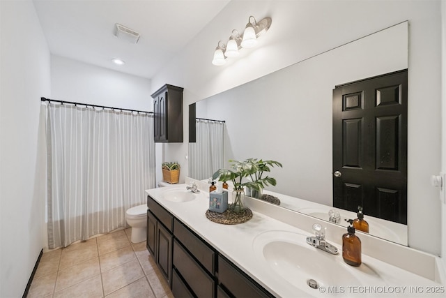 1018 W Evergreen St, Skiatook, OK 74070 - full bathroom with double vanity and tile patterned floors