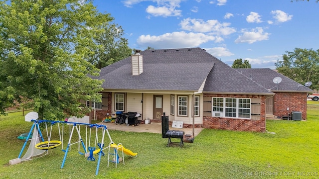 1018 W Evergreen St, Skiatook, OK 74070 - rear view of property featuring a lawn, a patio, brick siding, and a chimney