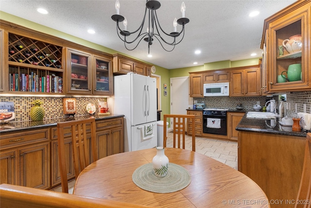 11420 S Mingo Rd, Bixby, OK 74008 - kitchen with white appliances, dark countertops, brown cabinetry, backsplash, and recessed lighting