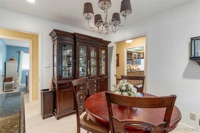 11420 S Mingo Rd, Bixby, OK 74008 - dining room featuring a chandelier and light colored carpet