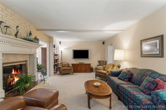 11420 S Mingo Rd, Bixby, OK 74008 - carpeted living area featuring a textured ceiling and a tiled fireplace