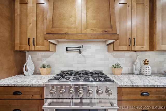 12526 S 12th St, Jenks, OK 74037 - kitchen with high end stainless steel range oven, brown cabinets, and light stone countertops