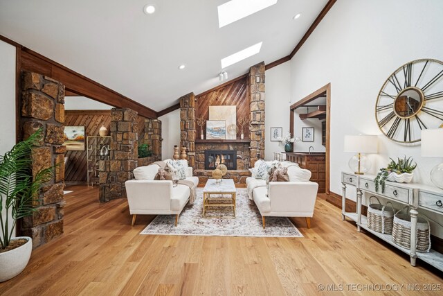 12526 S 12th St, Jenks, OK 74037 - living room with a fireplace, ornamental molding, light wood-style floors, high vaulted ceiling, and a skylight