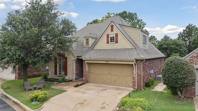 8404 E 98th Pl, Tulsa, OK 74133 - view of front of property with brick siding, roof with shingles, driveway, and a front lawn