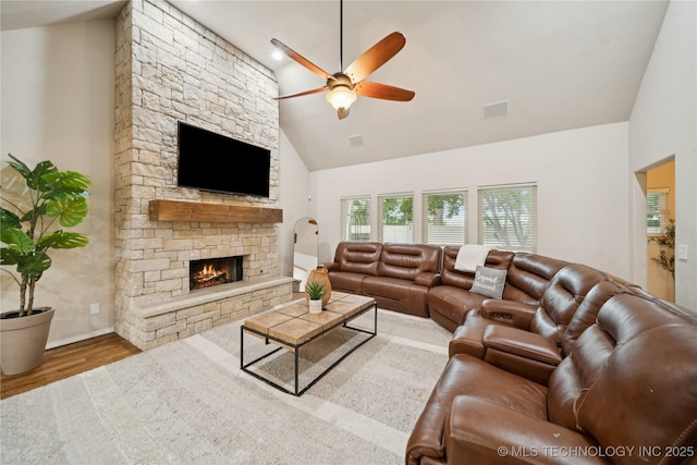 8404 E 98th Pl, Tulsa, OK 74133 - living room with a ceiling fan, wood finished floors, a stone fireplace, and high vaulted ceiling