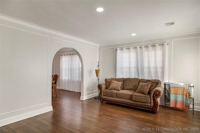 1510 S College Ave, Tulsa, OK 74104 - living area featuring arched walkways, ornamental molding, healthy amount of natural light, wood finished floors, and recessed lighting