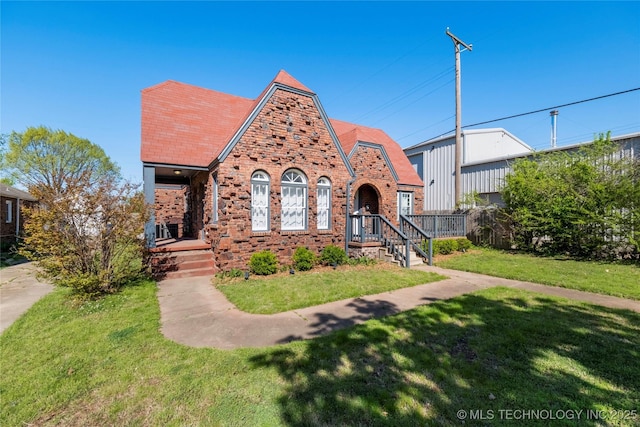 1510 S College Ave, Tulsa, OK 74104 - tudor house with brick siding, a front yard, and covered porch