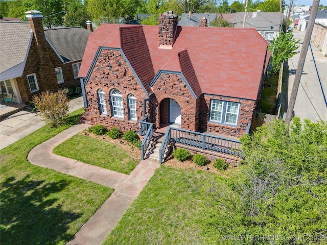 1510 S College Ave, Tulsa, OK 74104 - english style home with a chimney, a front lawn, stone siding, and brick siding