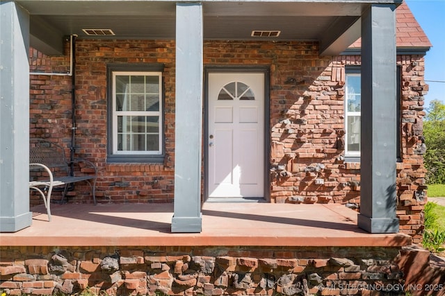 1510 S College Ave, Tulsa, OK 74104 - view of exterior entry featuring covered porch and brick siding